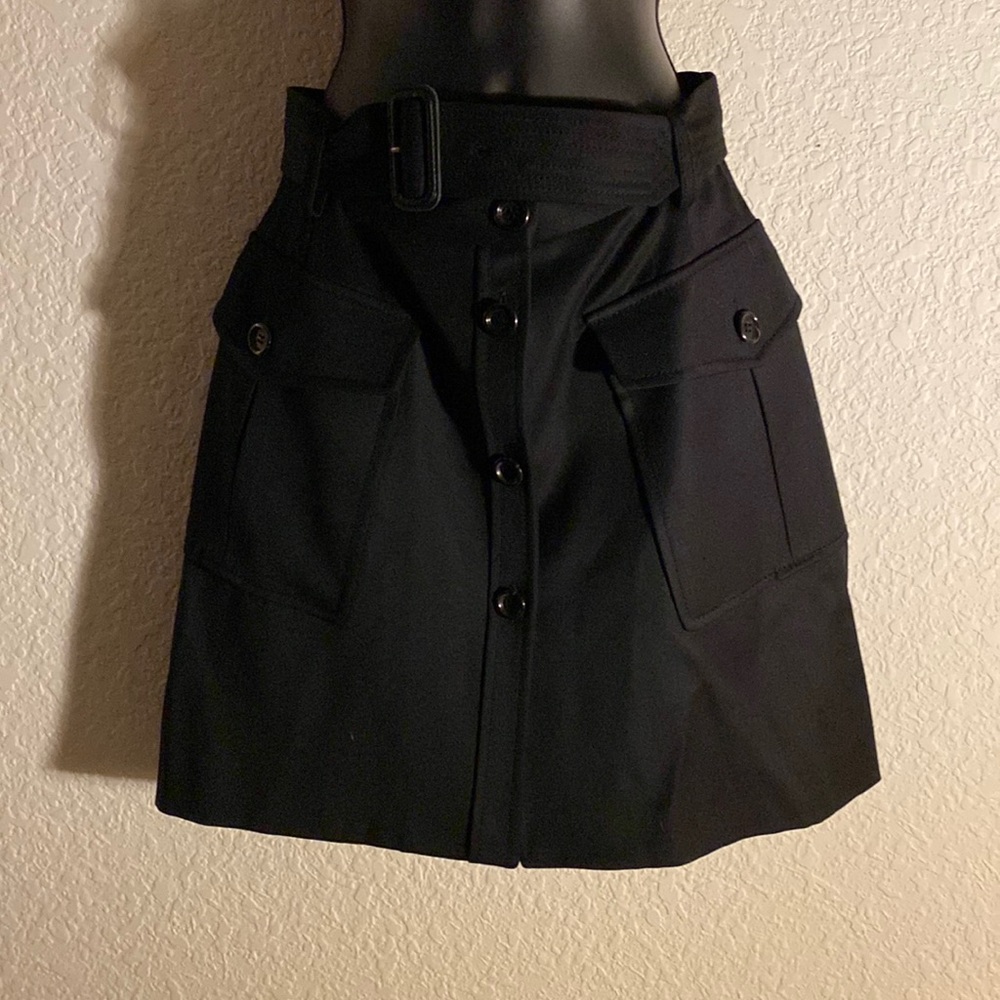Burberry London. Made in Italy. Size 4. 100% Wool. Black Skirt. Side pockets.